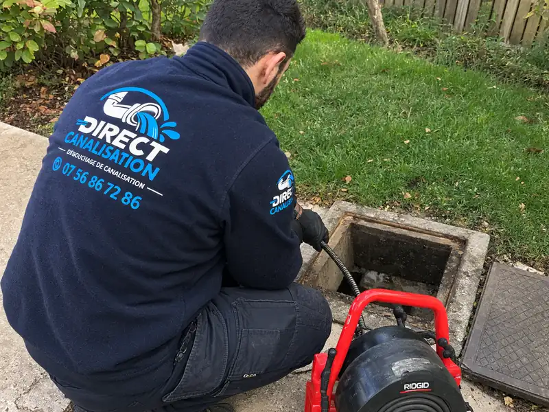 Technicien Direct Canalisation devant un regard extérieur avec un furet électrique à Lyon